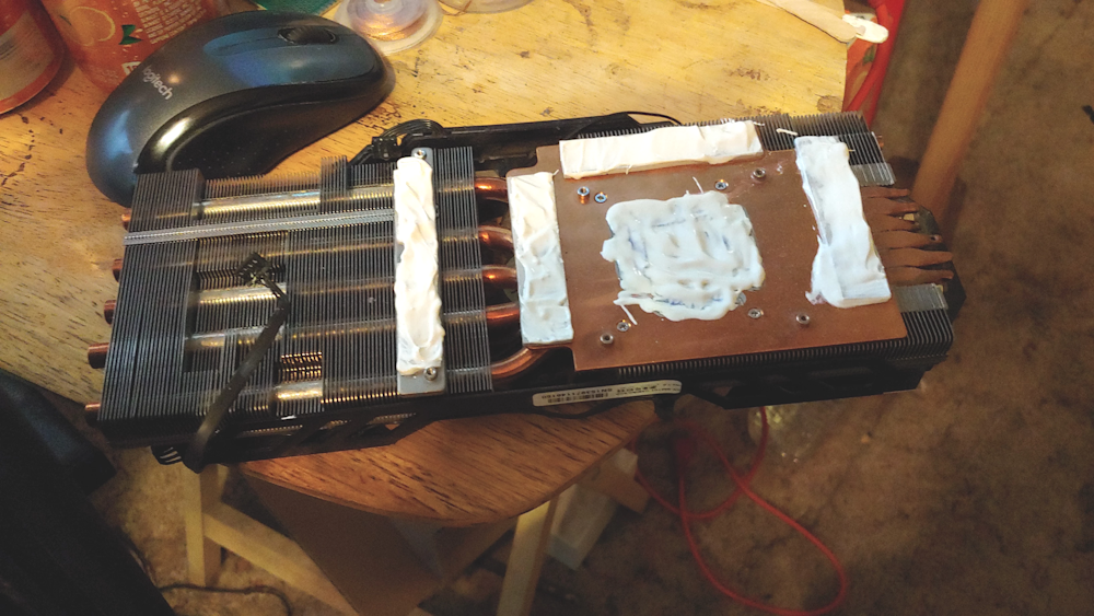 Fans and heatsink, loaded up with plenty of zinc oxide thermal paste and ready to be reattached.