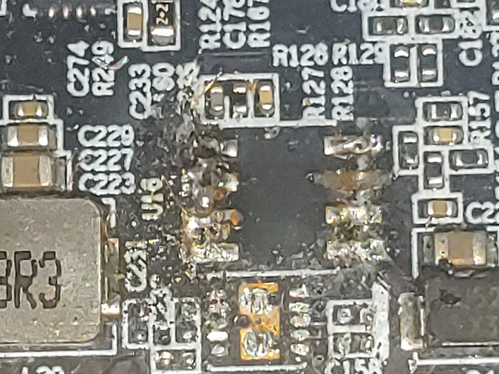 The burned-out buck converter removed from the graphics card.